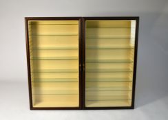 A set of three mahogany effect wall hanging display cabinets, each with twin moulded and glazed