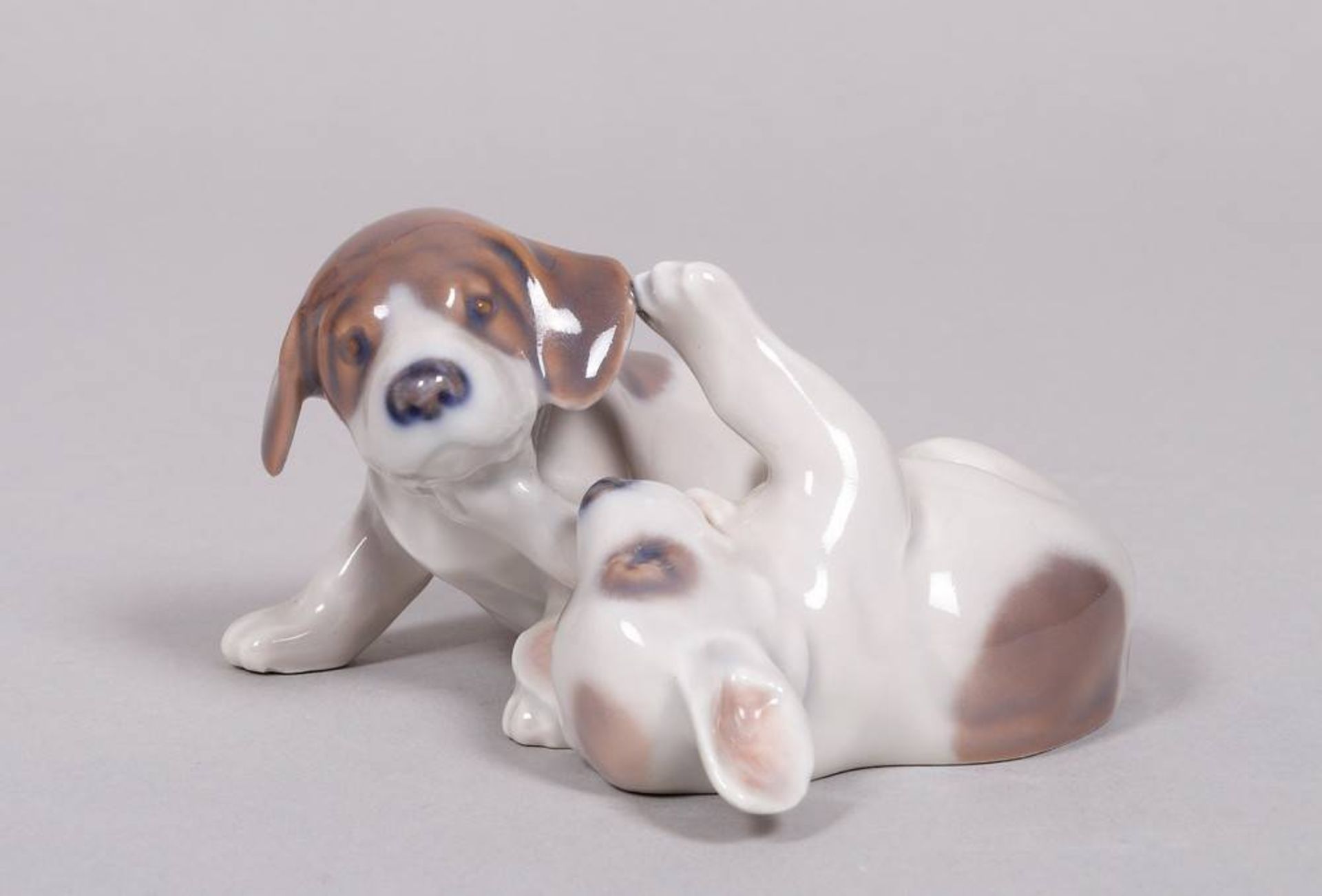 Group of puppies, design Erik Nielsen for Royal Copenhagen, 20th C.