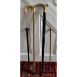 A collection of 4 sticks to include a swagger stick with white metal knop with indistinct crest, a
