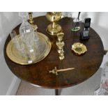 A George III oak tilt top table, circa 1780, circular top on a turned column raised on acanthus trio