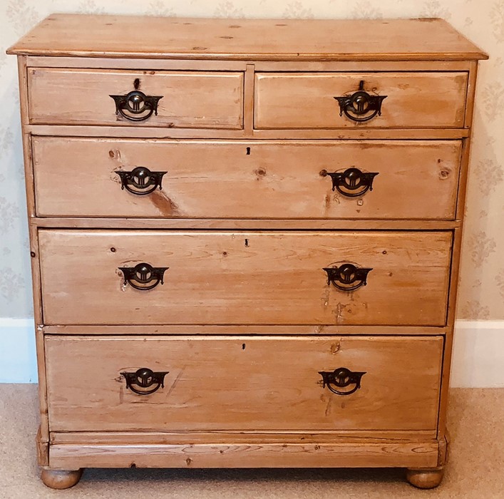 A late Victorian pine chest of drawers, slight oversailing moulded edge top, above two and three