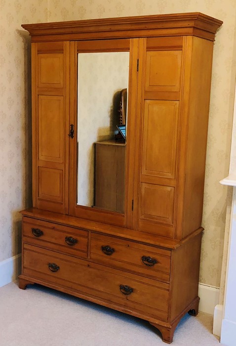 An Edwardian satin birch wardrobe, out swept moulded cornice above a single mirror inlay door,