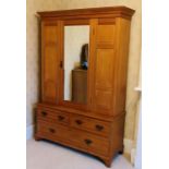 An Edwardian satin birch wardrobe, out swept moulded cornice above a single mirror inlay door,
