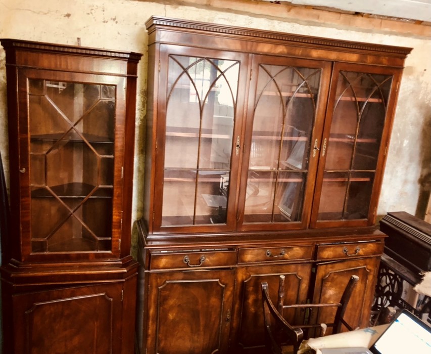 A 20th century mahogany bookcase, dental cornice above three glazed doors with Gothic style