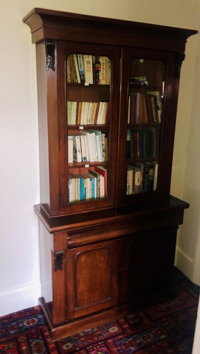 A Victorian mahogany library bookcase, circa 1880, moulded out-swept cornice above a two panel