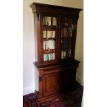 A Victorian mahogany library bookcase, circa 1880, moulded out-swept cornice above a two panel
