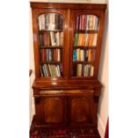 A Victorian mahogany library bookcase, circa 1860, slight oversailing pediment, above arch shaped