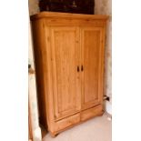 A 20th Century pine bedroom suite, his and hers wardrobes, a pair of bedside cabinets, blanket