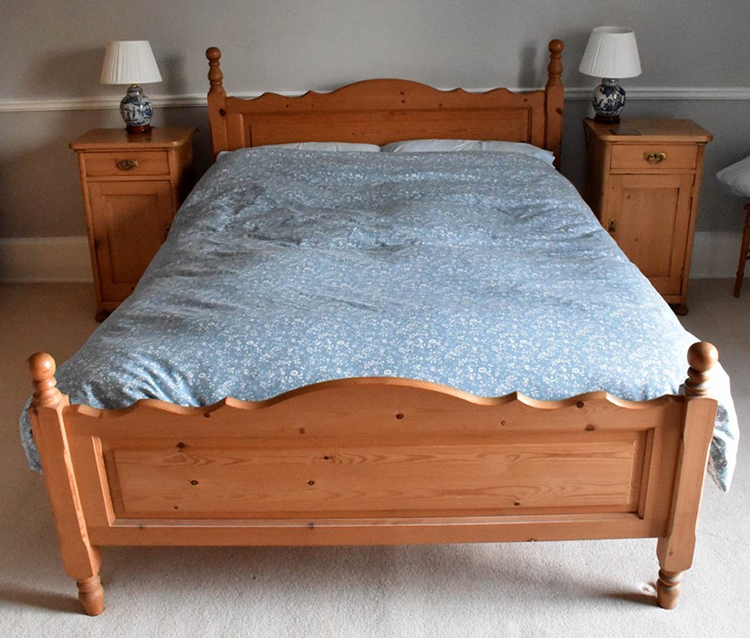 A 20th Century pine bedroom suite, double bed, pair of bedside cabinet, bedroom chair and