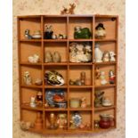 A collection of various items on a set of collectors shelves to include ceramic animals, felt