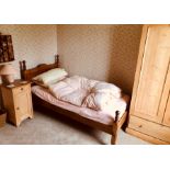 A 20th Century pine single bedroom suite, single bed, bedside cabinet and wardrobes. (3)