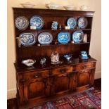 A George III revival oak dresser, moulded cornice over open two shelves, slight oversailing top
