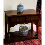 A Georgian style oak dresser base, rectangular moulded slight oversailing top, above two frieze