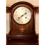 An early 20th Century mahogany and satinwood decorated mantle clock, arch top, German brass dial