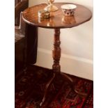 A George III oak wine table, circa 1820, raised on a turned column above acanthus tripod cabriole