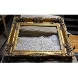 A gilded carved wood picture frame.