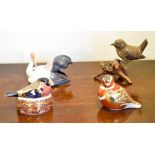 Four ceramic models of birds to include 2 Royal Crown Derby paperweights, Bullfinch Nesting and
