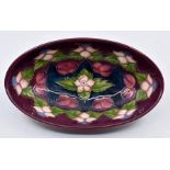 Moorcroft Pottery: A Moorcroft Collectors Club 'Morello' pattern oval tray. Length approx 23cm.