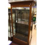 An Edwardian mahogany shop display cabinet, plain dentil moulded projected cornice, fitted with a