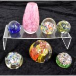 Six mid to late 20th Century glass paperweights, Murano and others, some are AF, along with pink