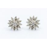 A pair of 9ct white gold and diamond set flower stud earrings, diameter approx 9mm, post and