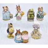 A collection of Beatrix Potter figures including Sally, Henny Penny, Aunt Pettitoes, Hunca Munca, Mr