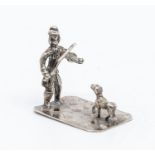 A Dutch silver miniature model of a Fiddler and a Dog, stamped, 14 grams