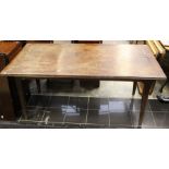 A late 19th Century oak refectory table, plank top with mitred ends, raised on turned square tapered