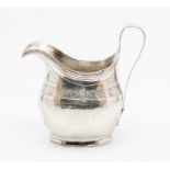 A George III silver helmet shaped cream jug, bright cut engraved with squiggle work, central