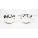 A George V plain silver circular milk jug and sugar bowl, hallmarked by Ernest W Haywood,