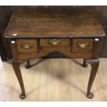 A mid 18th Century oak lowboy, fitted with three drawers, raised on cabriole legs, 73cm high, 77cm