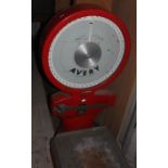 An Avery floor standing set of postage scales, 50kg max weight, in red, 116cm high, 65cm wide,