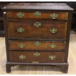 An early 18th Century oak and walnut cross-banded chest of drawers, circa 1730, of frame and panel