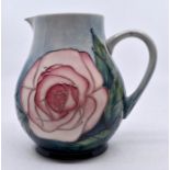 Moorcroft Pottery: A Moorcroft Collectors Club 'Pink Roses' jug. Height approx 14cm. Impressed