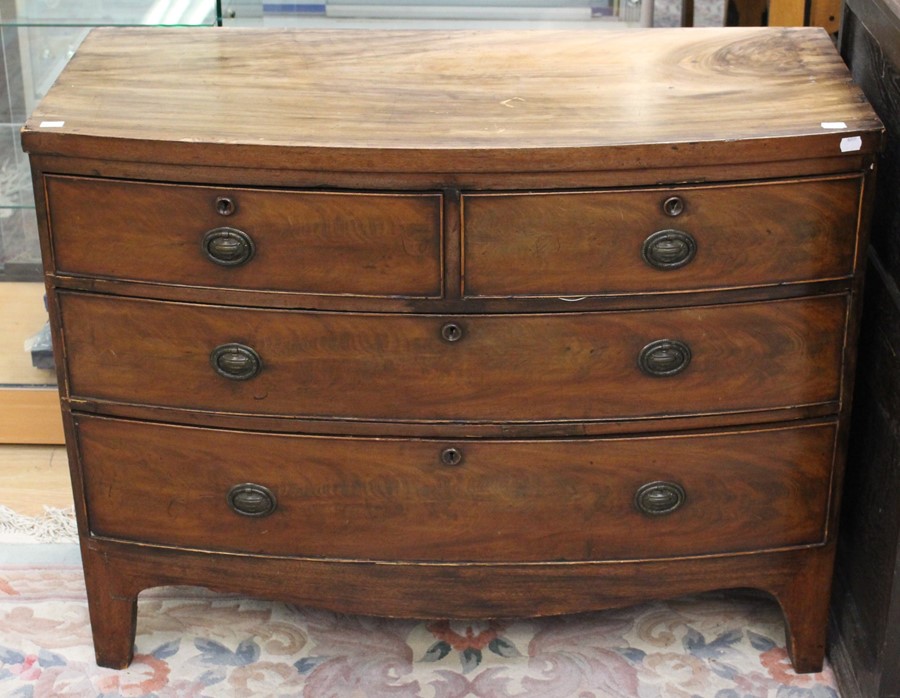 An early Victorian bow fronted mahogany chest of drawers, fitted with two short over two long