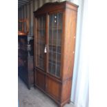 An early 20th Century glazed bookcase, fitted with two lead glazed doors and two panelled doors