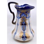 A Losol Ware 'Kensington' pattern ewer in blue/white and gold decoration. Height approx 35cm.
