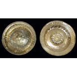 A 17th Century brass Alm's dish repousse circular centre with indistinct script, raised sides with