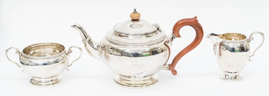 A George VI three piece silver tea service comprising teapot, milk jug and sugar bowl, plain