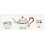 A George VI three piece silver tea service comprising teapot, milk jug and sugar bowl, plain