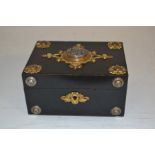 A North European style gilt and white metal mounted ebonised jewellery box, the cover inset with