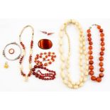 A collection of jewelery to include a banged agate brooch, agate bead necklaces, drop earrings, ring