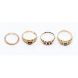 A collection of assorted 9ct gold rings, including two garnet set rings, a sapphire and white