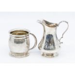 A George V silver plain barrel shaped mug, Birmingham, 1913 and a plain baluster shaped cream / milk
