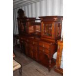 A late Victorian mirror backed sideboard, the upper section with two glazed doors, mirror to back