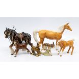 A collection of Beswick horses to include a palomino mare and foal, along with Wade Whimsies, two