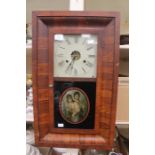 A 19th Century American saloon wall clock, mahogany glass front