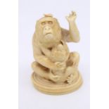 A Japanese late 19th Century carved figure of a Monkey and infant on a twisting rope base, the