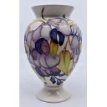 Moorcroft Pottery: A Moorcroft ' Purple Wisteria' vase designed by Emma Bossons. Height approx 18cm.