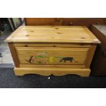 A 20th Century childs pine trunk, with incised cartoon scene to front, 48cm high, 91cm wide, 46cm